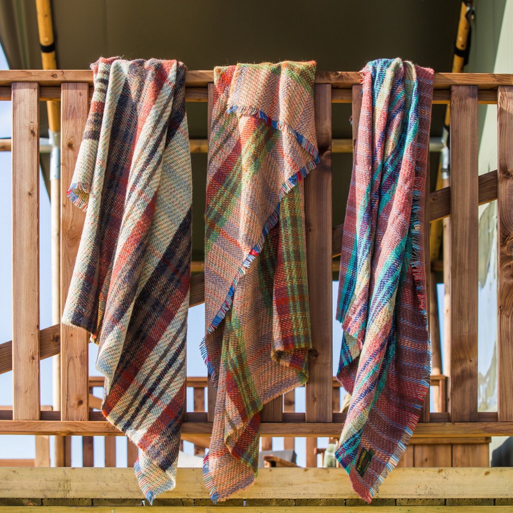 random recycled blankets draped over a side showing their unique and lovely patterns and colours